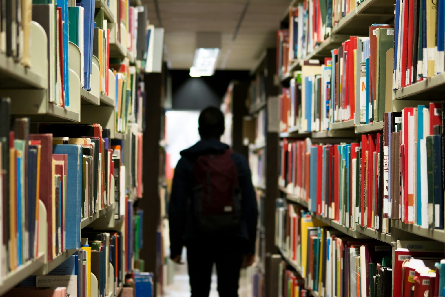 A student walking down a school library